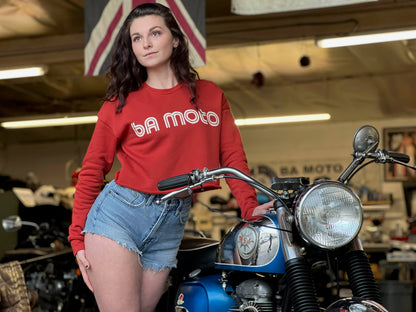 brunette standing next to motorcycle